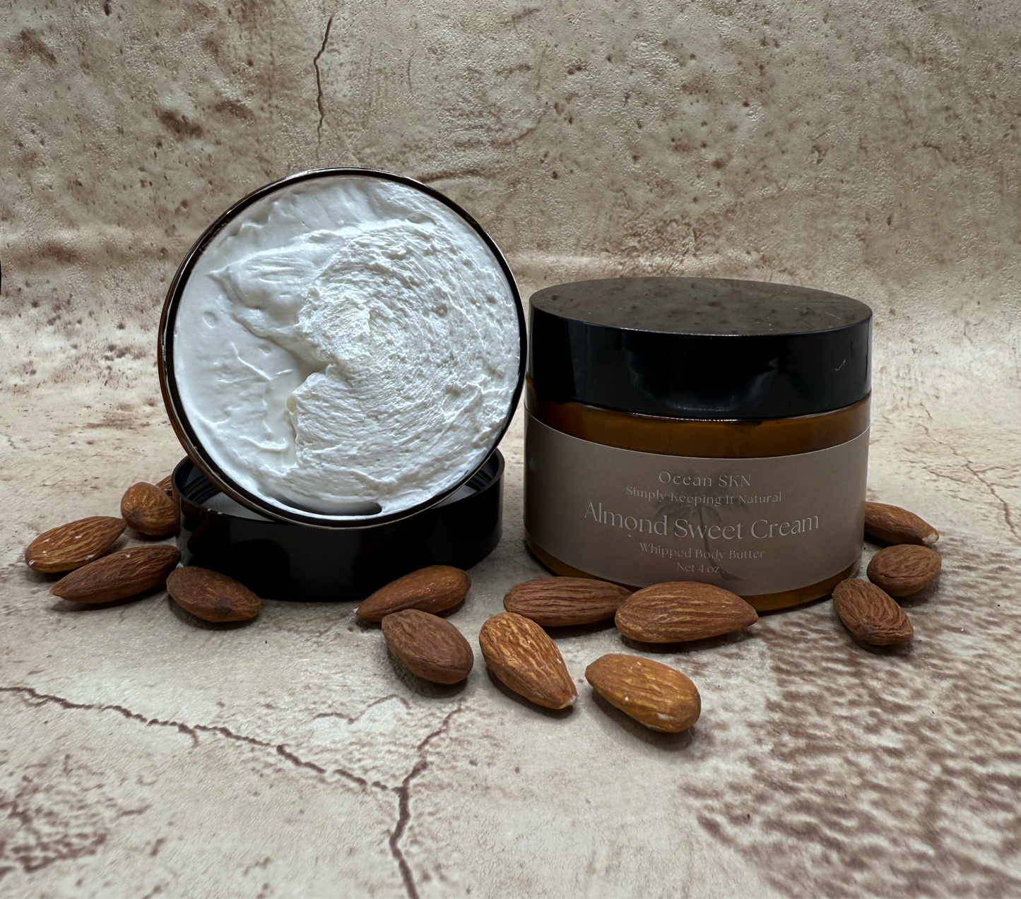 A jar of whipped body butter, with an Almond Sweet Cream scent by Ocean SKN.